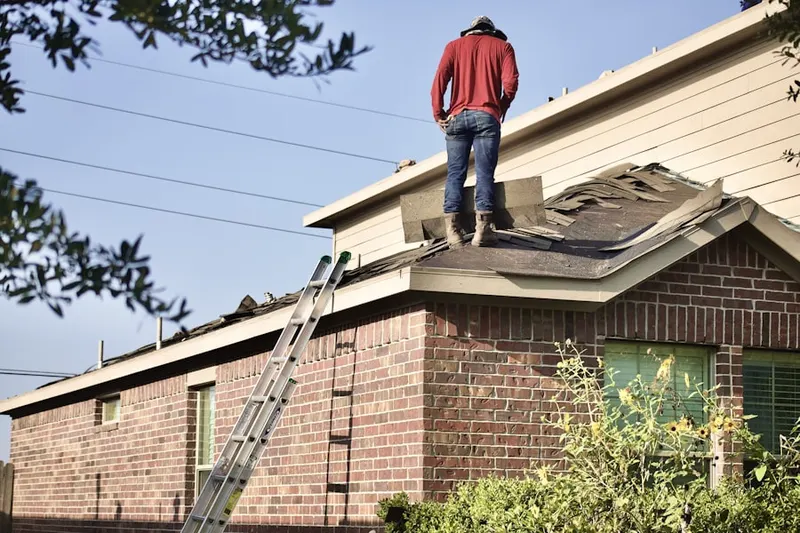 Professional roofer working on a residential roof in East Orange